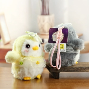 Detailed view of cute plush penguin pendants with lace dresses and pearl accents