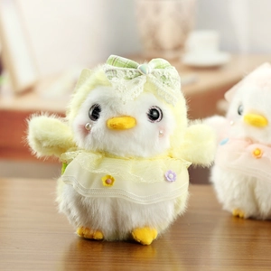 Close-up of cute plush penguin toy with lace bow and yellow dress for bag charms