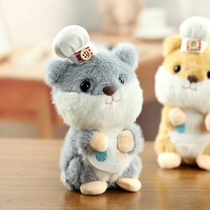 Macro detail of the chef hamster plush toy showing soft faux fur and miniature apron design