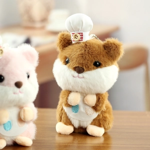 Close-up of cute plush hamster keychain wearing a white chef hat and colorful apron