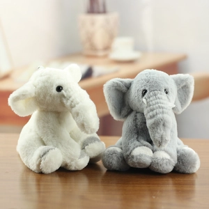 Detail of plush baby elephant toys in white and grey colors with soft furry texture