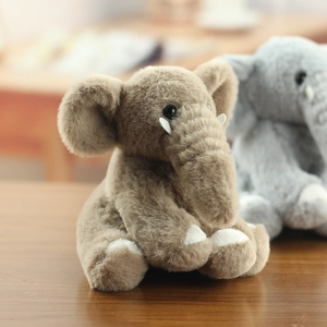 Close-up of soft plush mammoth elephant keychain featuring brown fur and white tusks
