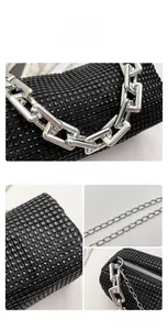 Detail of black rhinestone evening bag showing shiny crystals and silver metal chain strap