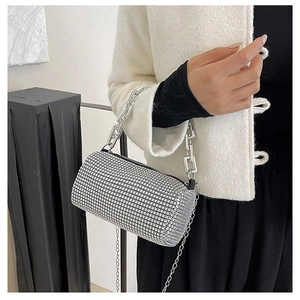 Silver rhinestone cylinder evening bag featuring a chunky chain handle and fine strap