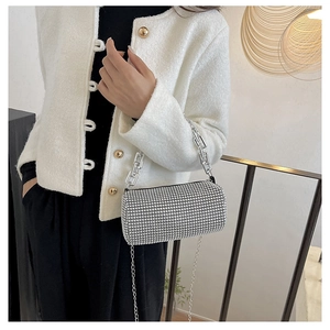 Detail of silver rhinestone cylinder bag with metallic ring handle and chain strap