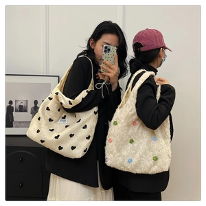 Mirror view of two large tote bags featuring heart prints and 3D floral textures