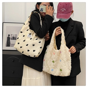 Detail of canvas tote with heart pattern and plush bag with 3D floral accents