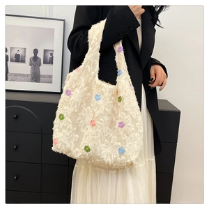 Close-up of a white textured tote bag with colorful 3D floral embroidery for women
