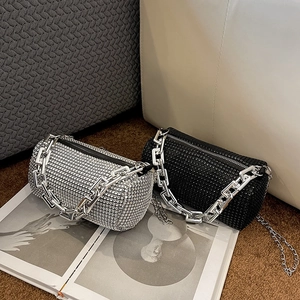 Fashionable cylinder handbag with sparkling rhinestones and bold silver metal chain