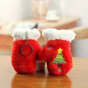 Detail of plush red Christmas glove ornaments with soft white fur trim and tree embroidery