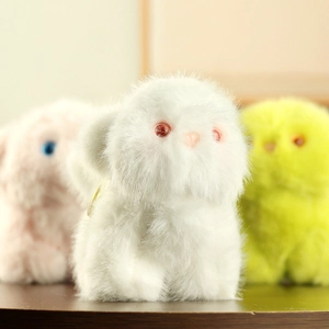 Detailed macro view of soft plush cat charms in white, pink and vibrant green colors