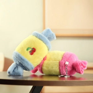 Close-up of colorful plush candy keychains with soft faux fur and cherry embroidery