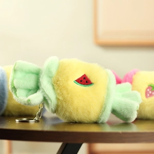 Macro detail of plush candy keychain featuring green watermelon embroidery and soft fur texture
