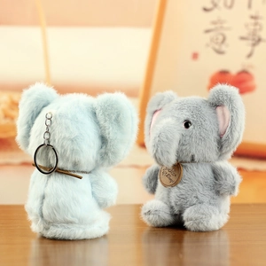 Detail of plush elephant keychains in blue and gray with soft fur and metal rings