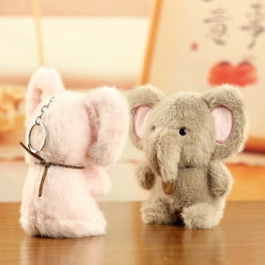 Detail of plush elephant charms in pink and grey with soft fur texture and metal keychains