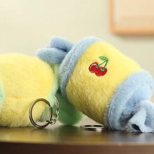 Close-up of soft candy-shaped plush keychain with cherry embroidery and silver metal ring