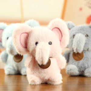 Close-up of soft plush elephant toys in pink, blue, and grey with a leather tag