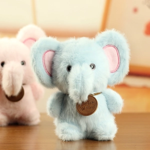 Close-up of soft plush elephant keychain pendants in pastel pink and light blue colors
