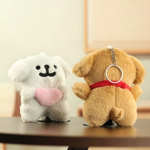 Detail of plush puppy keychains in white and brown with soft texture and heart accent