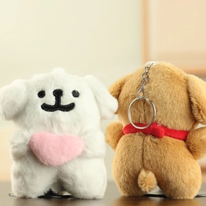 Close-up of fluffy puppy plush keychains with pink heart and soft plush texture detail