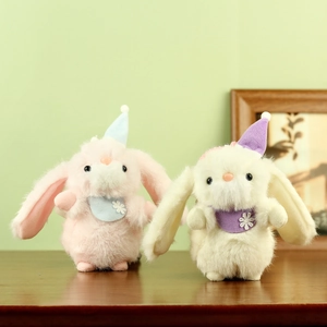 Plush bunny keychains with long ears and cozy outfits on a wooden surface
