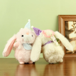 Plush bunny keychains in pink and white with colorful pointed hats and decorative collars