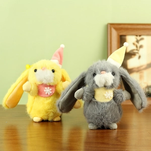 Detail shot of cute plush rabbits with long ears and floral scarves on a wooden table