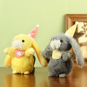 Close-up of yellow and grey plush rabbits with party hats and festive snowflake bibs