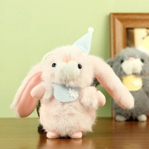 Close-up of pink plush bunny with blue party hat and embroidered snowflake scarf