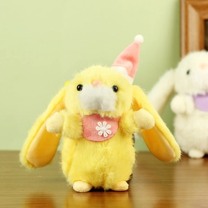 Close-up of yellow plush rabbit doll wearing a pink party hat and floral bib accessory