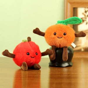 Cute plush fruit keychain set with fluffy apple and orange characters on a wooden table