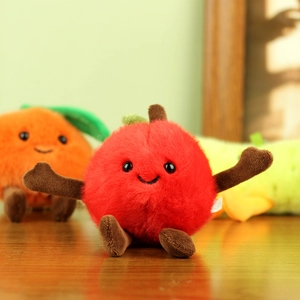 Detailed plush texture of cute apple and orange fruit toys with embroidered smiling faces