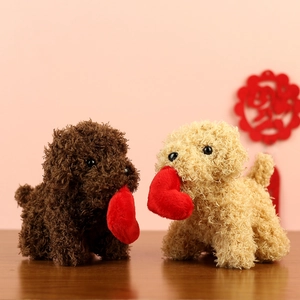 Cute teddy dog plush toys in brown and cream with heart pendants on wooden table
