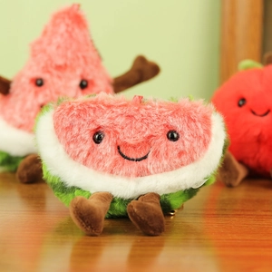 Close-up of soft plush watermelon keychain with cute embroidery and dangling brown limbs