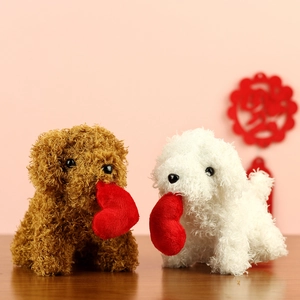 Detail view of brown and white teddy dog plush toys holding red hearts on a wooden table