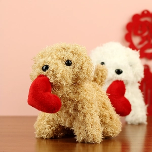 Detail of brown and white plush teddy dogs holding a red heart for Valentine's Day gift