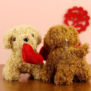 Detail of plush teddy dog charms with curly fur and red heart accents on pink background