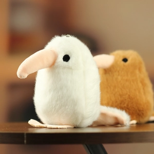 Close-up of white and brown plush kiwi bird keychains with realistic soft faux fur texture