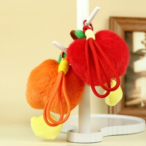 Portachiavi in peluche a forma di frutta rossa e arancione con cinturini intrecciati