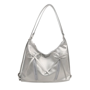 Silver metallic tote bag with bow details and zippers for a stylish 2024 look