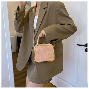Pink box evening clutch with floral embossed faux leather and gold chain strap shown on model