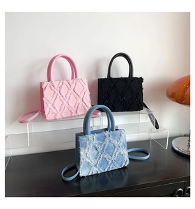 Detail of quilted tote bags featuring frayed edges in pink, blue, and black finishes