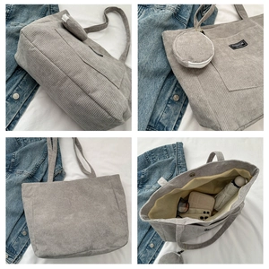 Detail of gray corduroy tote bag featuring fashion label and spacious interior storage