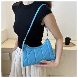 Close-up of quilted sky blue shoulder bag showing elegant rhombic stitching texture