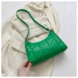 Close-up of bright green quilted shoulder bag with premium faux leather and gold zipper