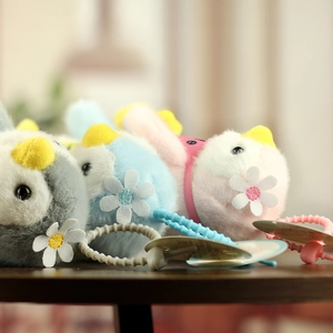 Detailed view of plush penguin baby rattles with colorful plastic rings for sensory play