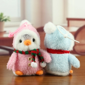Détail de porte-clés pingouins en peluche avec écharpes colorées et crochets sacs