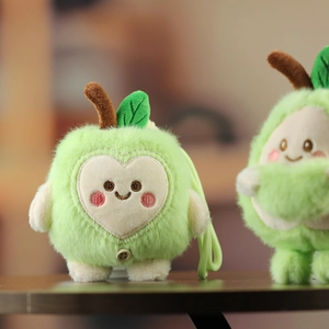 Close-up of cute plush avocado charm with heart detail and green lanyard for bags