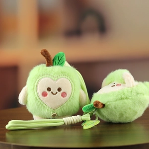 Close-up of cute plush apple charms with soft heart-shaped faces and green woven straps