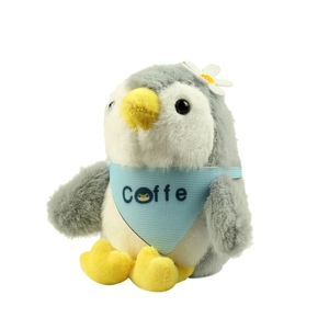 Cute penguin plush keychain with blue bib and flower decoration on white background